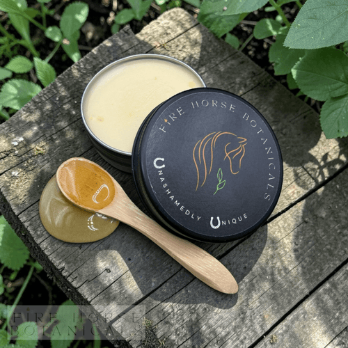 Fire Horse Botanicals product on a wooden surface with greenery in the background