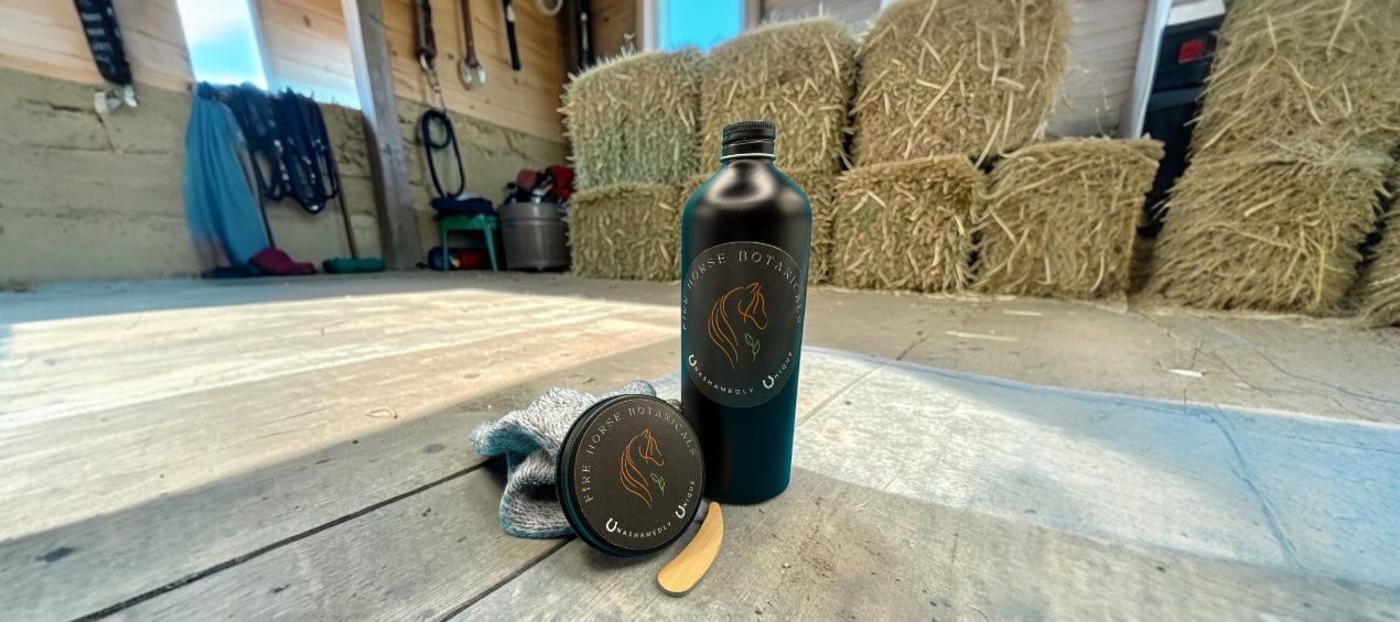 Fire Horse Botanicals tin and bottle with labels on a wooden floor with hay bales in the background