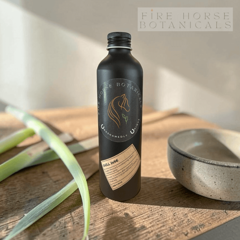 Black bottle with 'Fire Horse Botanicals' branding on a wooden surface.