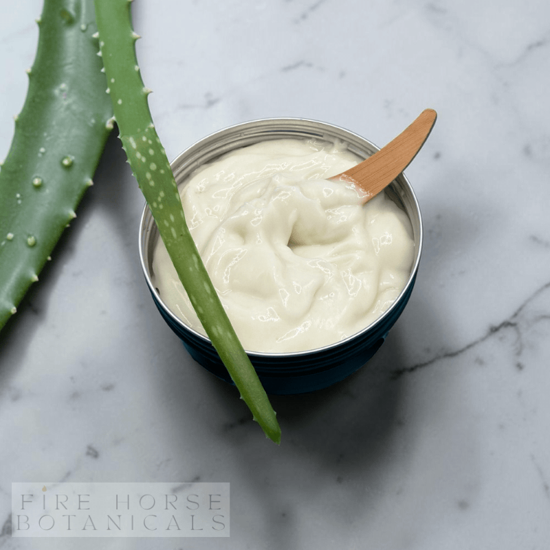 Tin of 'Fire Horse Botanicals' gel with aloe vera leaf on a marble surface, featuring Fire Horse Botanicals branding.