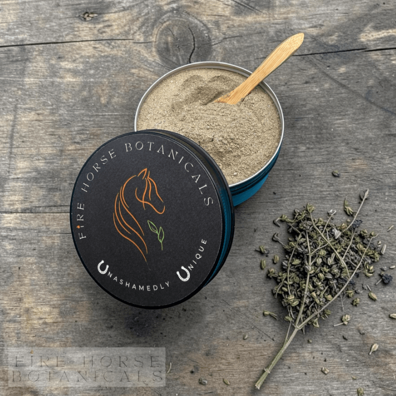 Open tin of Fire Horse Botanicals product on a wooden surface with a wooden spoon and dried herbs.