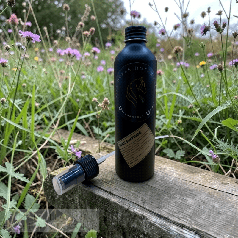 Black bottle with pump on a wooden surface with flowers in the background, 'Fire Horse Botanicals' branding