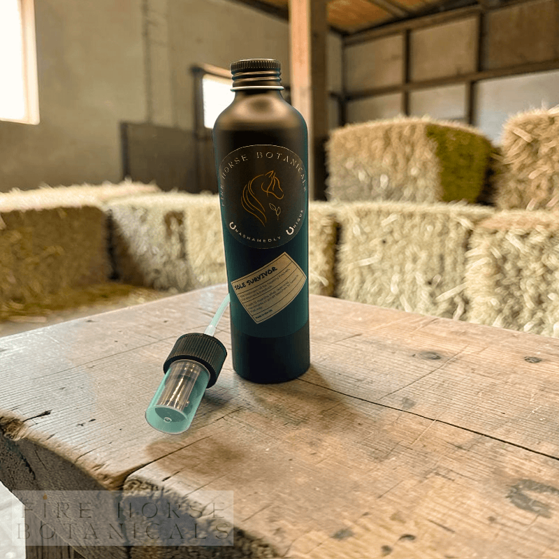Bottle and pump on a wooden surface with hay bales in the background and 'Fire Horse Botanicals' branding.