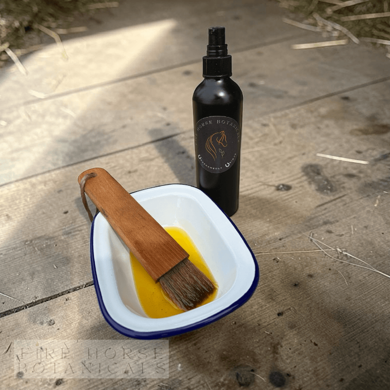 Bottle, tray and brush with 'Fire Horse Botanicals' product on a wooden surface