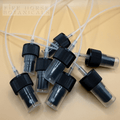 Set of black spray nozzles for bottles with Fire Horse Botanicals branding on a beige background